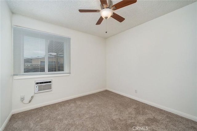 spare room with ceiling fan, light colored carpet, a wall mounted AC, and a textured ceiling