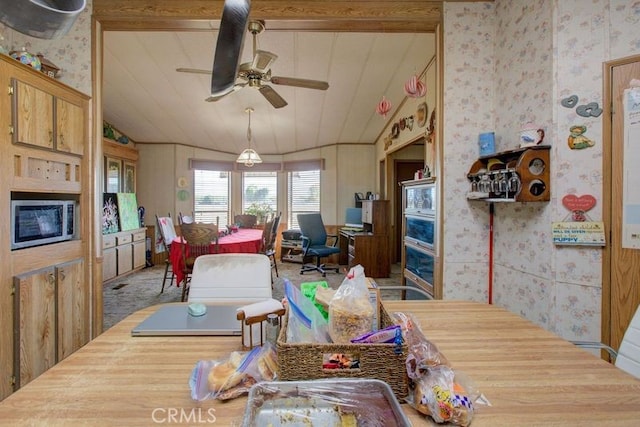 dining area with ceiling fan and lofted ceiling