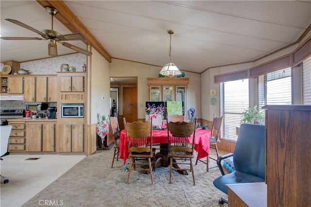 dining space with ceiling fan and lofted ceiling