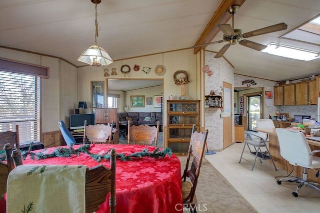 dining room featuring ceiling fan and vaulted ceiling with beams