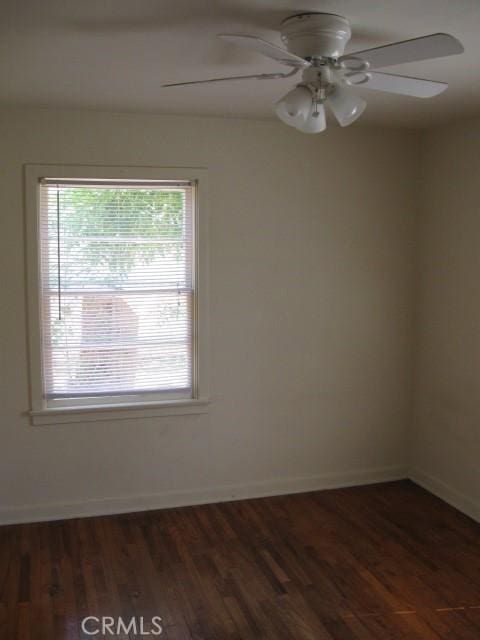 spare room featuring ceiling fan and dark hardwood / wood-style floors