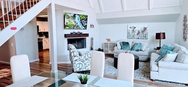 living room with wood-type flooring and vaulted ceiling