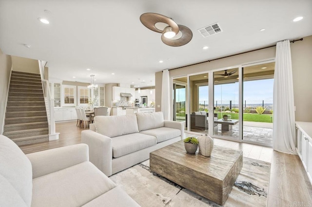 living room featuring light wood-type flooring and plenty of natural light