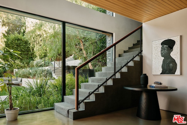 stairs featuring wood ceiling