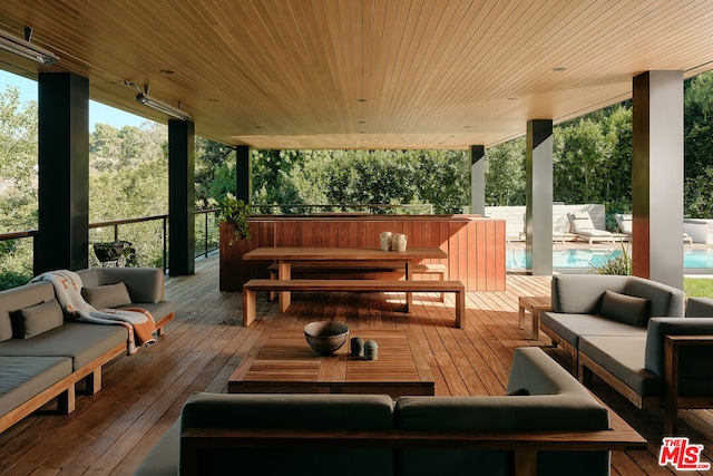 wooden terrace featuring an outdoor living space