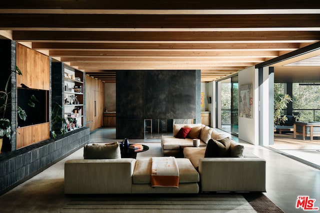 living room featuring beam ceiling and concrete flooring