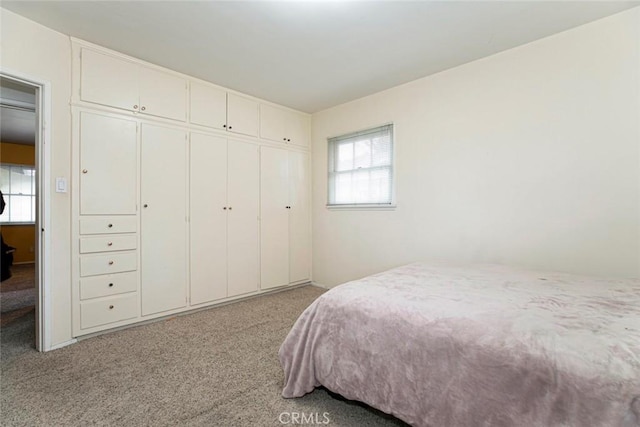 bedroom featuring light carpet