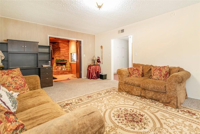 living room featuring carpet floors and a textured ceiling