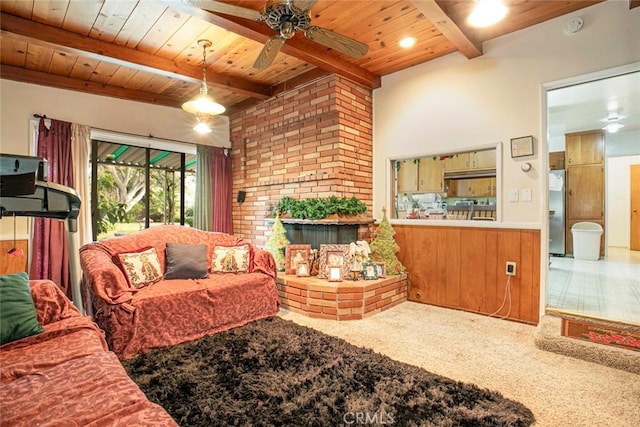 living room featuring ceiling fan, carpet flooring, wood ceiling, and beamed ceiling