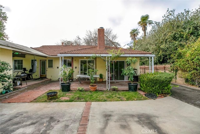 rear view of property featuring a patio area