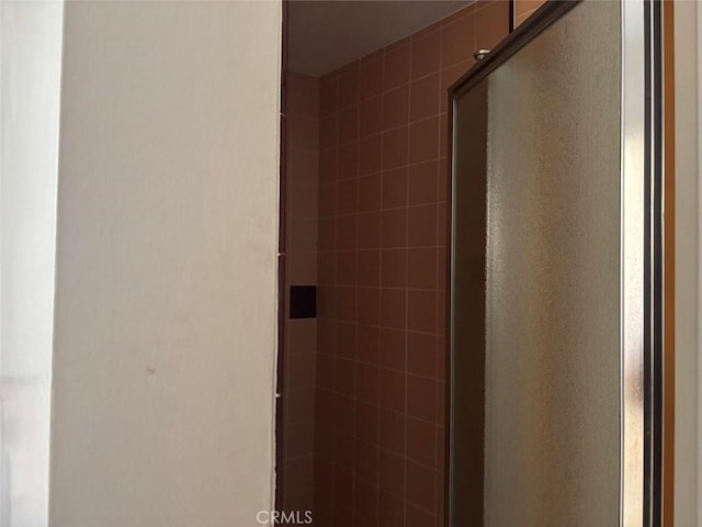 bathroom with a shower with shower door