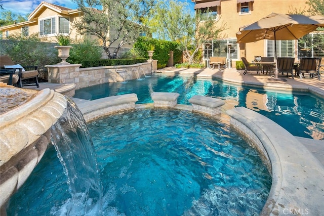 view of pool with pool water feature, an in ground hot tub, and a patio