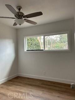 unfurnished room with light wood-type flooring and ceiling fan