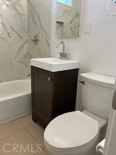 full bathroom with toilet, vanity, tile patterned flooring, and tiled shower / bath