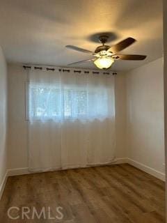 spare room with ceiling fan and hardwood / wood-style flooring