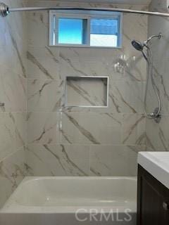 bathroom featuring vanity and tiled shower / bath combo