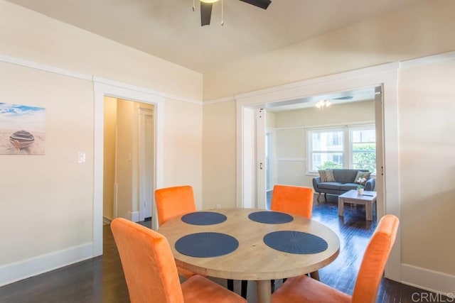 dining space featuring dark wood-type flooring and ceiling fan