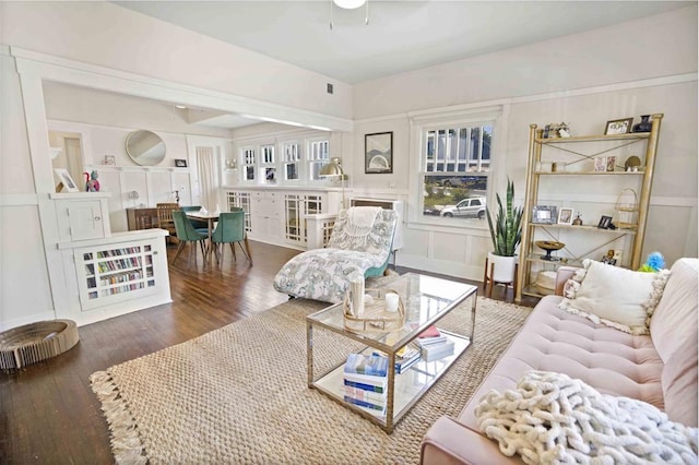 living room featuring ceiling fan and dark hardwood / wood-style flooring