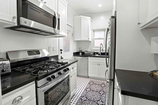 kitchen with appliances with stainless steel finishes and white cabinetry