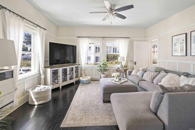 living room featuring ceiling fan, dark hardwood / wood-style flooring, and a healthy amount of sunlight