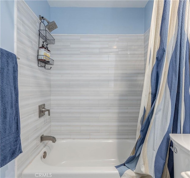 bathroom featuring toilet and shower / bathtub combination with curtain