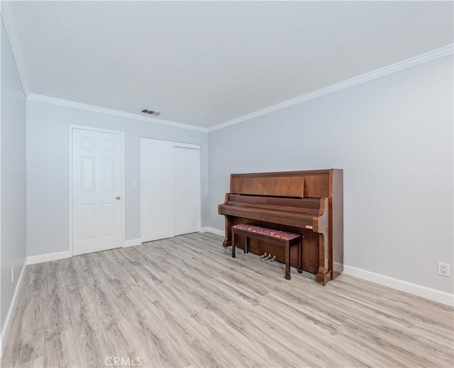 miscellaneous room featuring light hardwood / wood-style flooring and ornamental molding