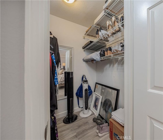 clothes washing area featuring hardwood / wood-style flooring