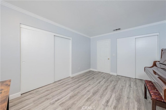 bedroom with ornamental molding and light hardwood / wood-style floors