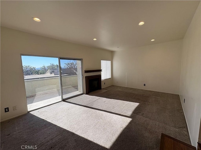 unfurnished living room featuring dark carpet