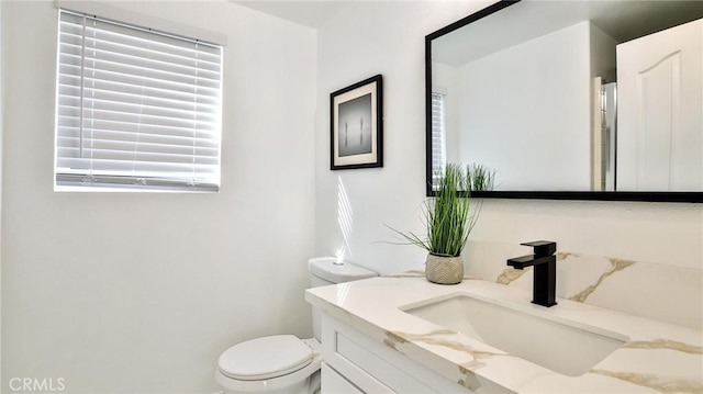 bathroom featuring toilet and vanity