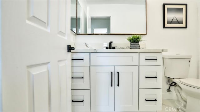 bathroom featuring toilet and vanity