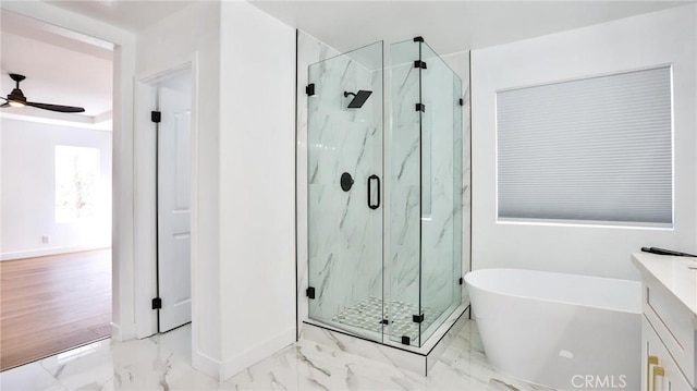 bathroom with ceiling fan, vanity, and separate shower and tub