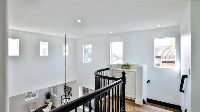 hallway featuring light wood-type flooring and a wealth of natural light