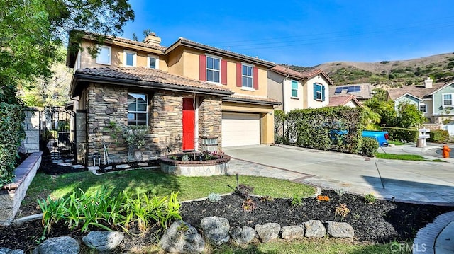 view of front of home with a garage and a mountain view