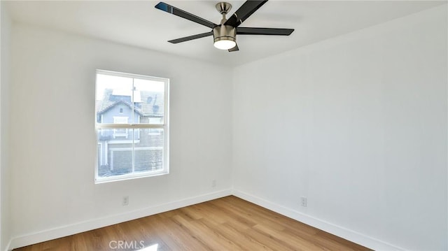 empty room featuring ceiling fan and light hardwood / wood-style flooring