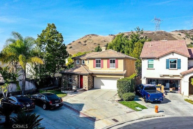 front facade featuring a mountain view and a garage