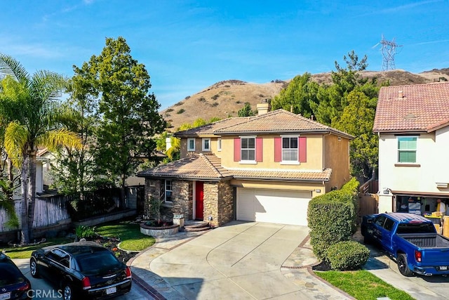 view of front of property with a garage and a mountain view