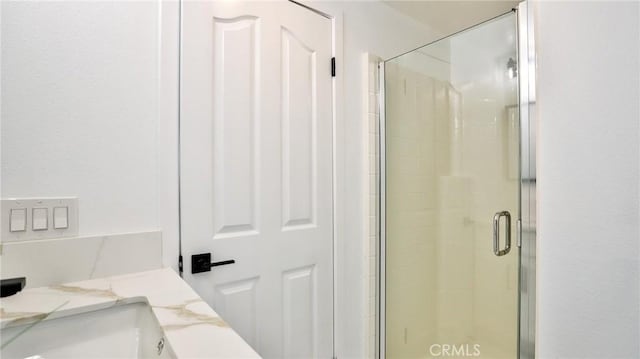 bathroom with an enclosed shower and vanity