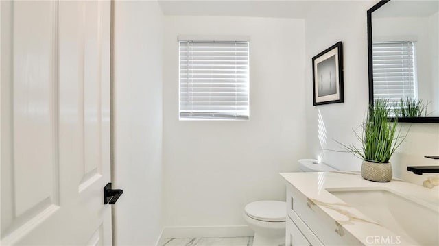 bathroom with toilet and vanity