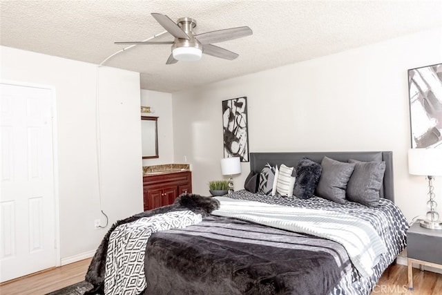 bedroom featuring ceiling fan, a textured ceiling, and light hardwood / wood-style flooring