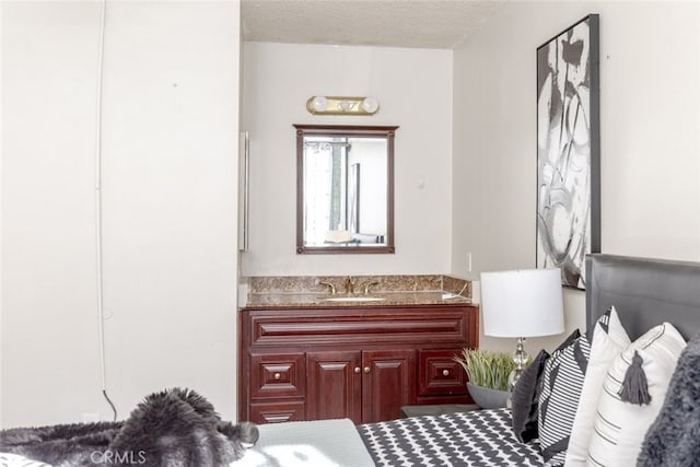 bathroom featuring a textured ceiling and vanity