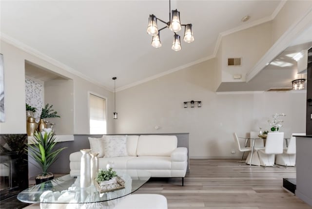 living room featuring wood-type flooring, a notable chandelier, and ornamental molding