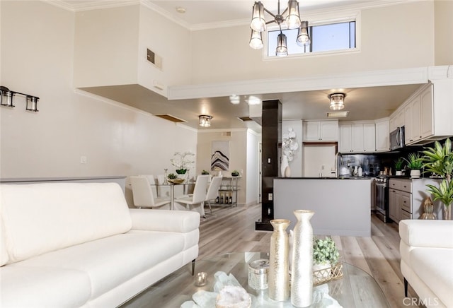 living room with light hardwood / wood-style flooring and ornamental molding