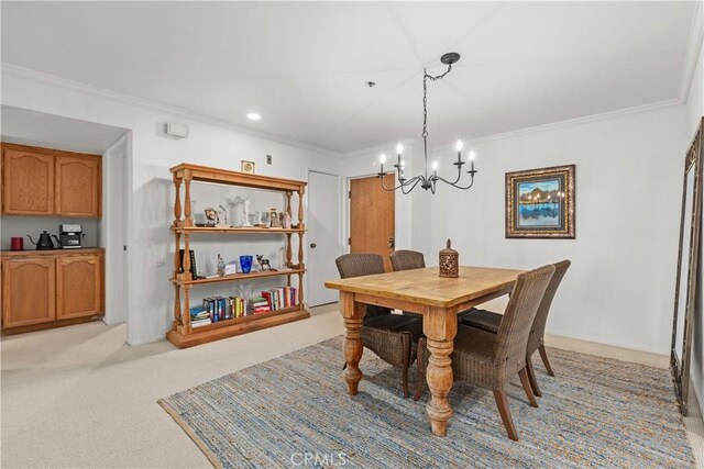 carpeted dining room with a notable chandelier and crown molding