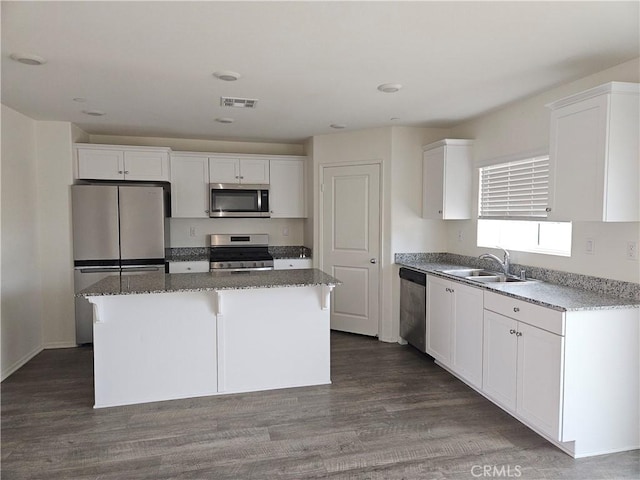 kitchen with sink, white cabinetry, a center island, and stainless steel appliances