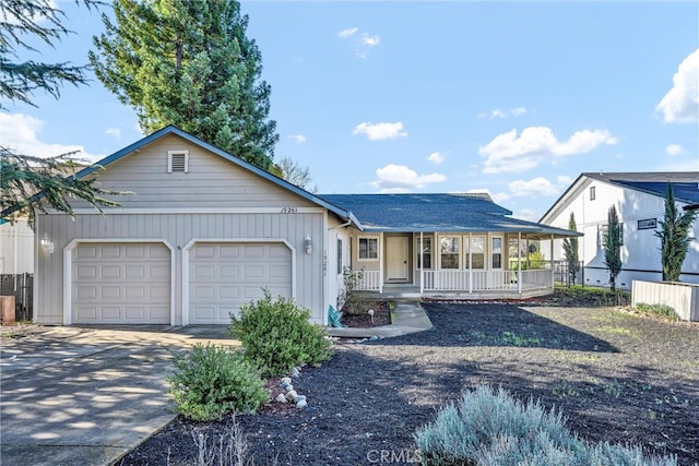 single story home with a garage, covered porch, and driveway