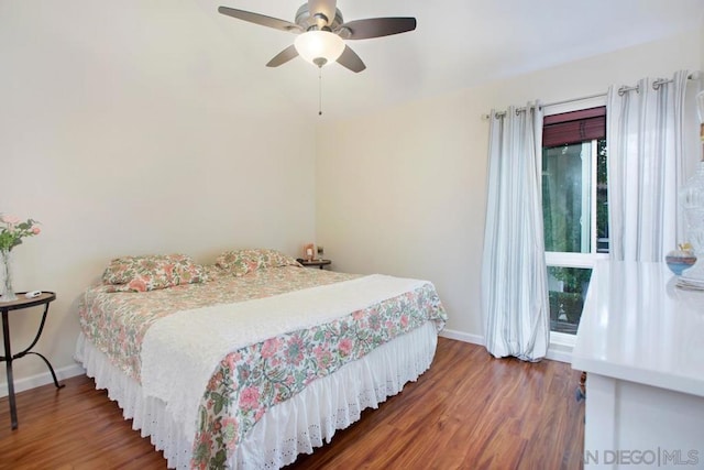 bedroom with dark hardwood / wood-style floors and ceiling fan