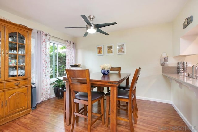 dining area featuring hardwood / wood-style floors and ceiling fan