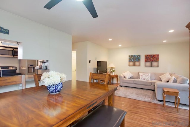 dining area with ceiling fan and light hardwood / wood-style flooring