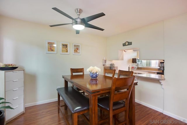 dining room with ceiling fan, dark hardwood / wood-style floors, and sink